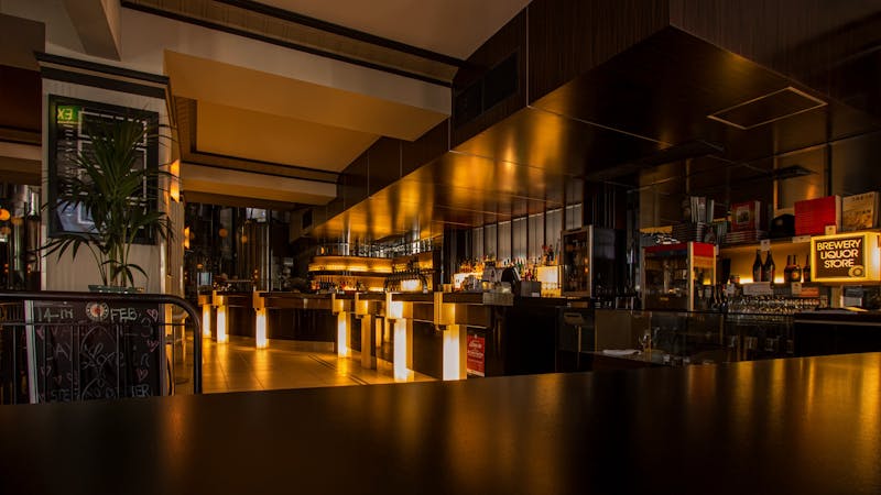 Restaurant and bar interior with ambient lighting, representing the hidden cost of dining out regularly